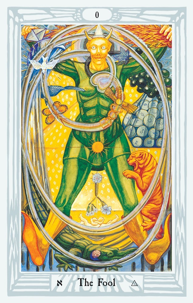 card labeled "the fool." image depicts a man in green clothing wearing a crown, a dog latched onto his leg.