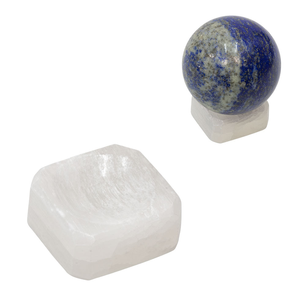 small block of matte white crystal. a blue spherical crystal sits on top
