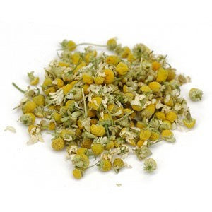pile of dried chamomile flowers